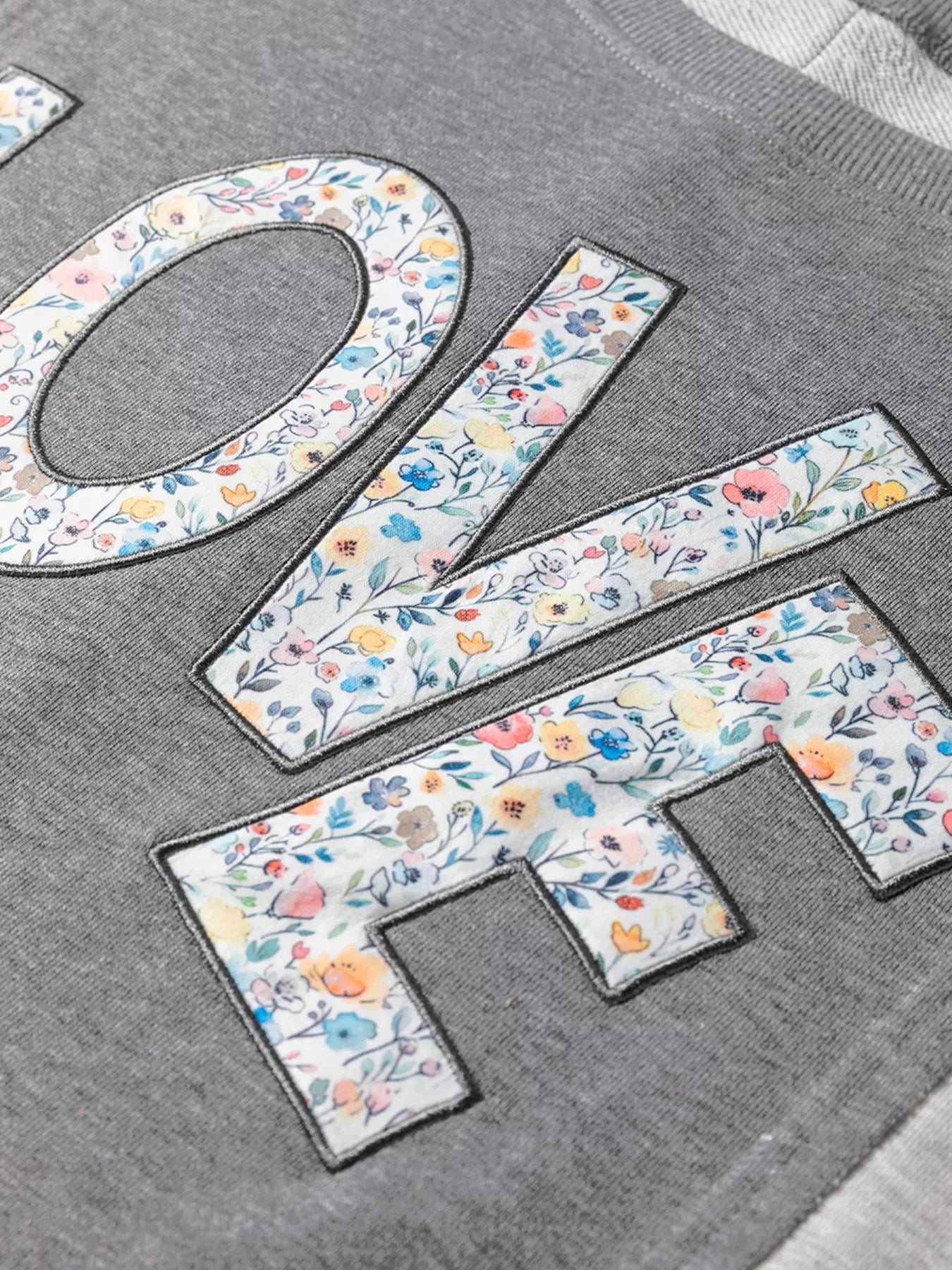 Exposed Seam Patchwork Uneven Hem LOVE Graphic Sweatshirt - Be Bliss Boutique