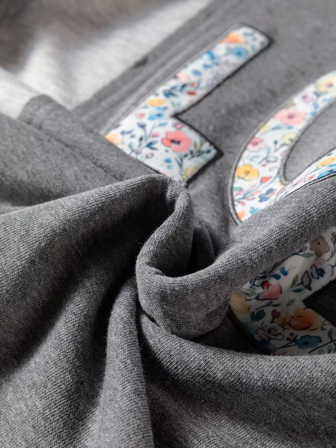 Exposed Seam Patchwork Uneven Hem LOVE Graphic Sweatshirt - Be Bliss Boutique